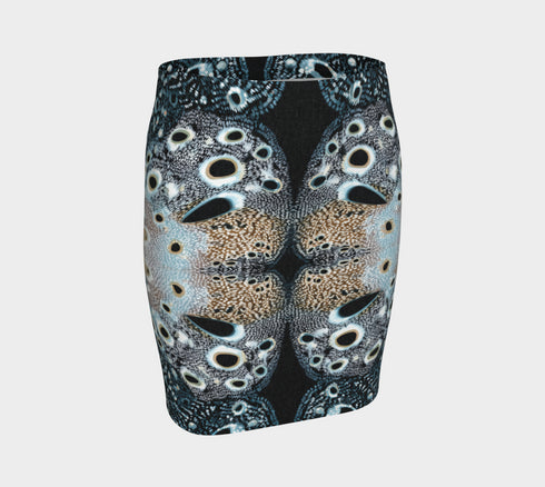 A high-waisted, bodycon mini skirt with a tight, fitted silhouette ending mid-thigh. The skirt features a vibrant, all-over graphic print inspired by a deer pelt. The pattern consists of a white and light blue textured base covered in irregular royal blue spots of varying sizes, creating a mesmerizing, psychedelic animal print effect. The skirt is made from a smooth, stretchy performance knit fabric with a subtle sheen, designed to hug the body's curves. The elastic waistband is seamless.